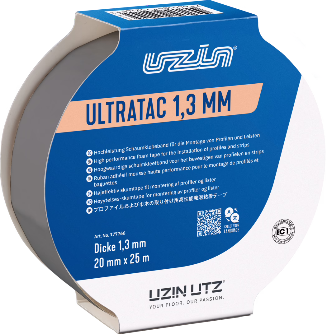 UZIN_Dummy_Ultratac 1,3-20mm_2026-02 Close-up of a roll of adhesive foam tape in blue-and-white packaging labeled 'ULTRATAC 1,3 MM'. Visible details include the gray foam core, product dimensions '20 mm x 25 m', thickness '1,3 mm', multilingual usage instructions, a barcode and a QR code, and part of the cardboard dispenser with the LIZIN UTZ logo.